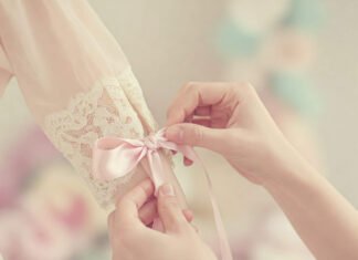 The Coquette Aesthetic: Outfits That Embrace Your Feminine Era Tying a pink satin bow on lace