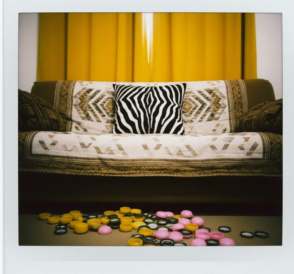 Retro Clashing Decor: Zebra Pillow, Mustard Curtains, and Bottlecaps