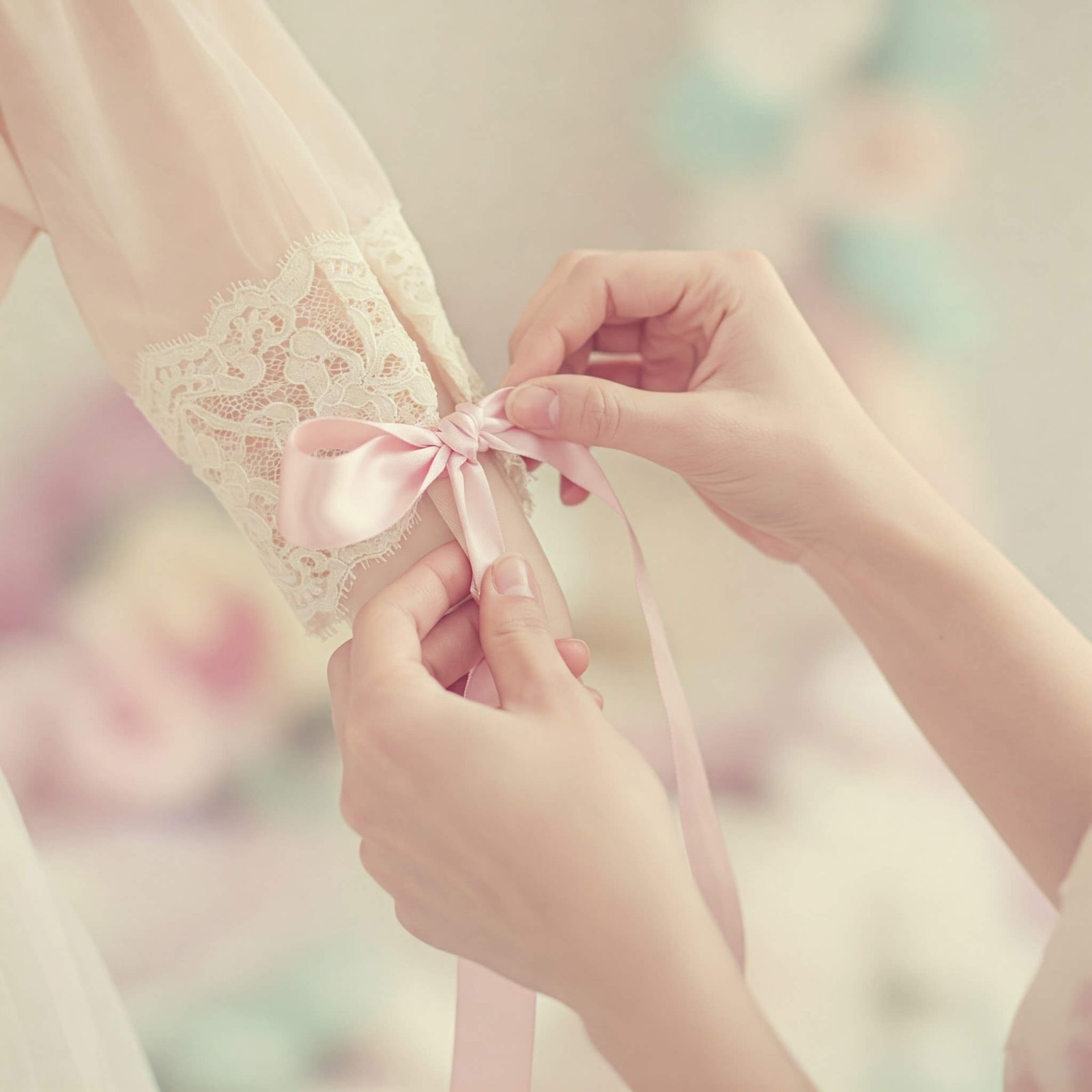 The Coquette Aesthetic: Outfits That Embrace Your Feminine Era Tying a pink satin bow on lace