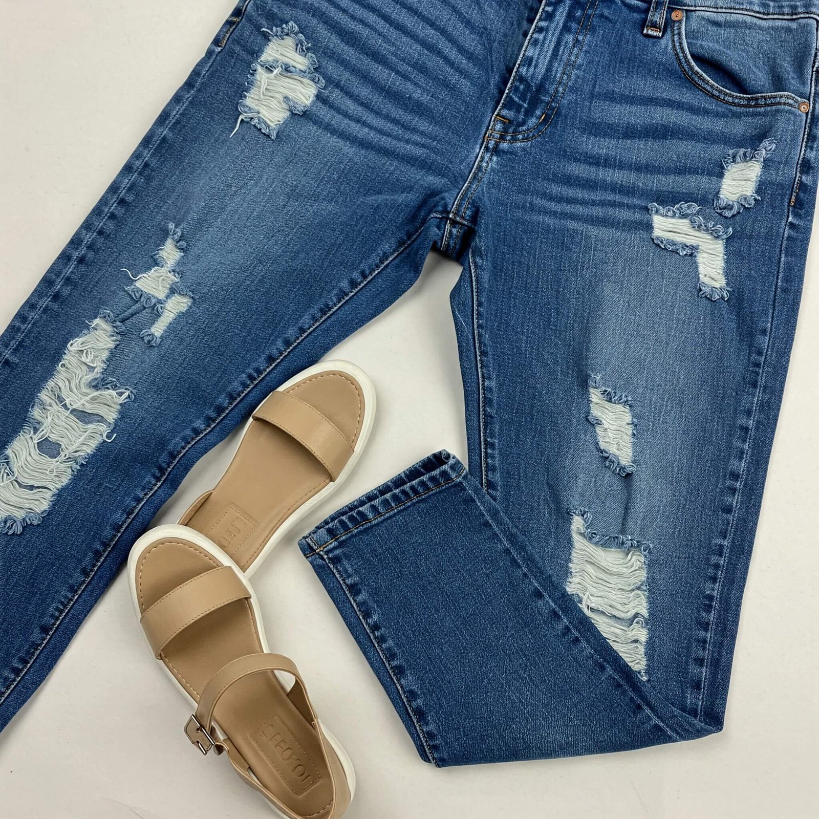 Makeup for Textured Skin: Tips from Real People, Not Just Influencers "Ripped jeans and tan sandals flat lay"