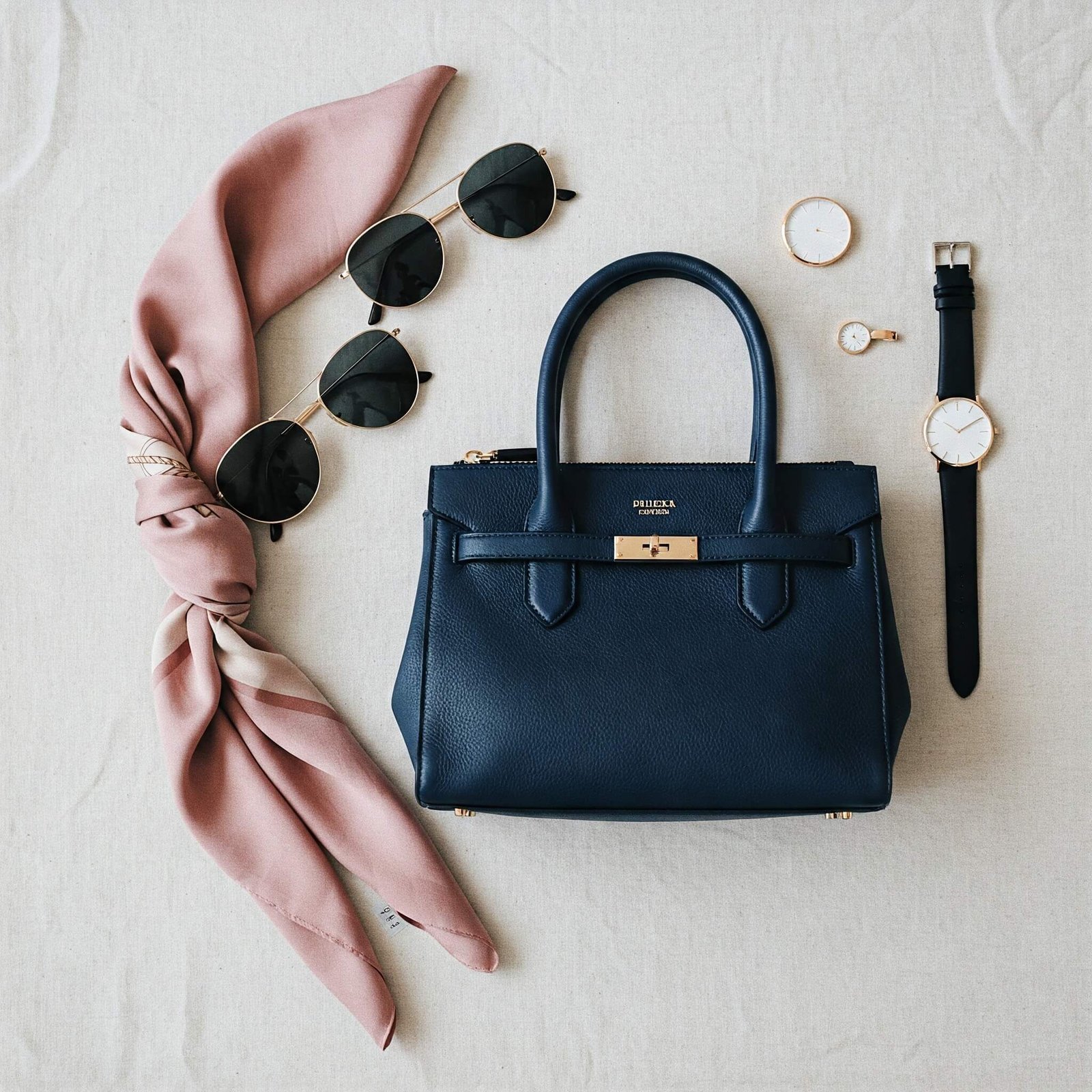 The Best Luxury Bag Dupes That Are Totally Worth It "Luxury dupe bag flat lay"