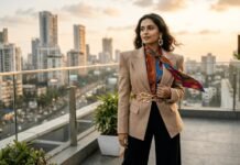 Confident Indian woman in tan blazer at golden hour.